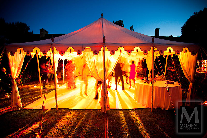 An illuminated photo of people dancing on the dance floor in an Indian marquee in the evening at Sheldon Manor