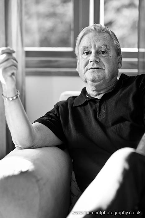 Black and white Portrait of author Neil Grimmett sitting talking to camera