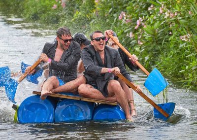 Men raft racing in suits at the Lowland Games in Thorney Somerset
