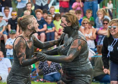 Two young women covered in mud, mud wrestling in Thorney, Somerset