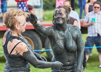 Two young women covered in mud, mud wrestling in Thorney, Somerset